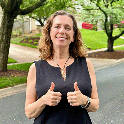 Lisa from SimpleStrongRestoration, LLC giving a thumbs up outdoors